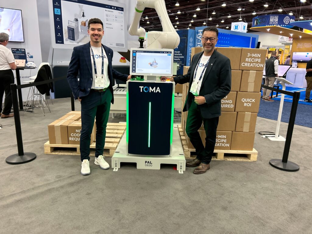 TOMA’s Antoine Pilon and Anthony Siblall pose at Automate in Detroit, Michigan, in front of the company’s PAL Series palletizer, designed for end-of-line packaging applications. Pilon is the company’s market development manager and Siblall is the vice president of strategic development.