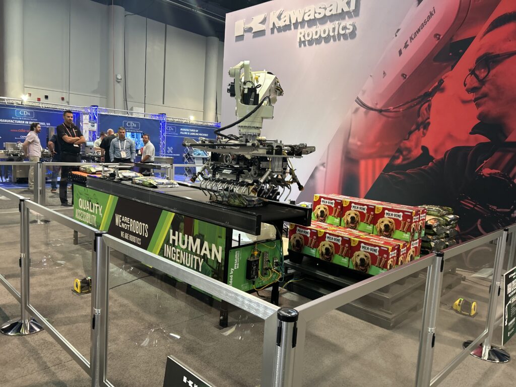 Kawasaki Robotics’ palletizing robot was shown moving large bags of pet food and treats at Pack Expo Las Vegas. The system has a max payload of 180 kg and features an energy regenerating controller.