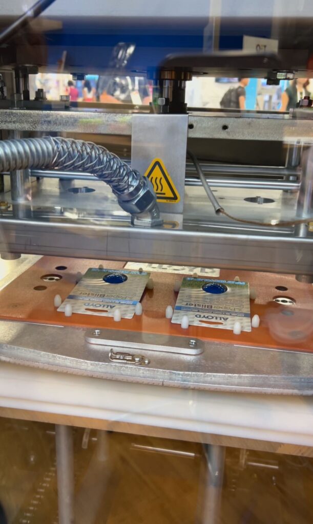 TOPPAN spotlighted its Aergo 8, a blister packaging machine, at Pack Expo. The system features eight nesting trays for products and was demonstrated packing golf balls at the Las Vegas Convention Center. Photo taken on September 30, 2025.
