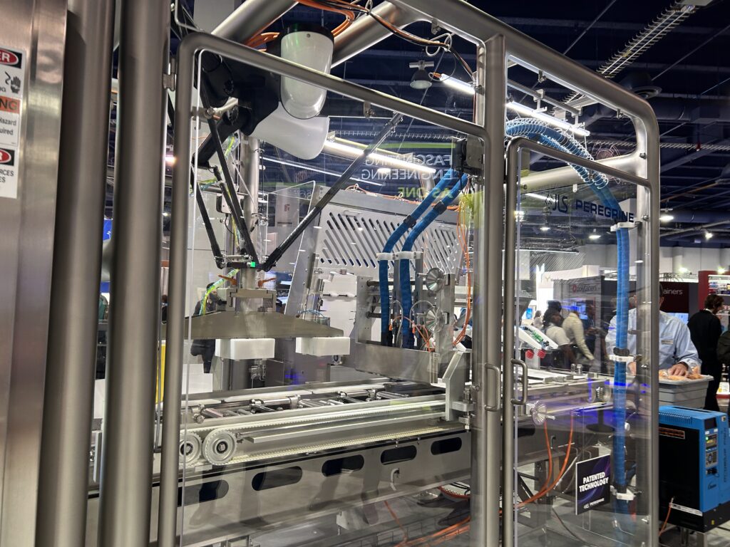 JLS Automation displayed its new Peregrine robotic cartoning system at Pack Expo Las Vegas. The system takes primary packages from upstream machines such as a flow-wrapper, thermoformer, or vertical form fill seal, and uses robotics to place them into a top-load carton. 
