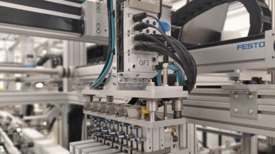 Key components of a Harris Hill Automation handling system include the custom tool with six Festo pneumatic grippers, the VTUX I/O module, and the X, Y, and Z axes that transport the end-of-arm tool. The System Configurator can help engineers sketch out and plan these components.