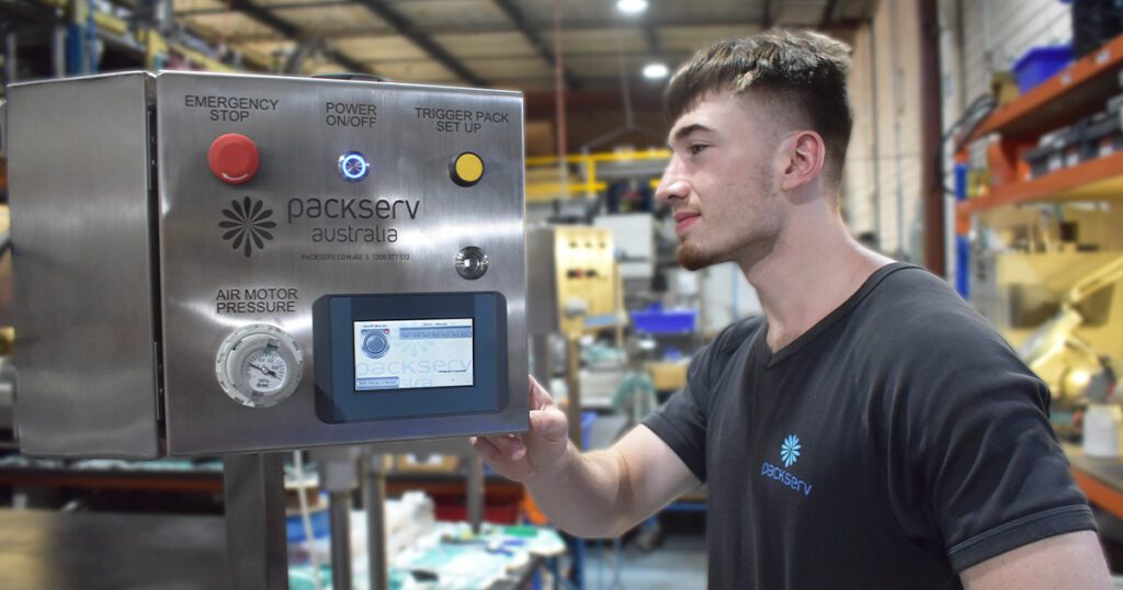 Operator using Packserv’s Industry 4.0-enabled PLC capping machine touchscreen HMI to manage production, reduce downtime, and simplify setup.