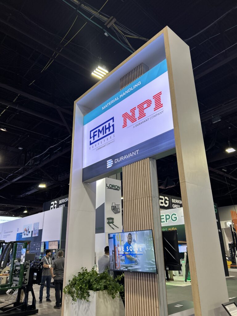 A view of the Duravant booth at Modex 2026 in Atlanta, Georgia, featuring signage highlighting material handling brands FMH Conveyors and NPI, both Duravant companies.