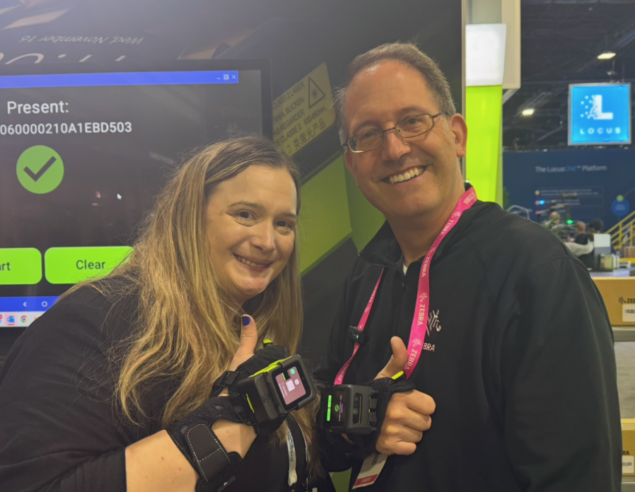 Dan Baldwin, global product manager at Zebra Technologies, and Sarah Wynn, senior editor (digital) for Packaging OEM, at Modex 2026 in Atlanta, Georgia, wearing Zebra’s WS501-R RFID wearable computers, which support short-range UHF RFID and 1D/2D barcode scanning.