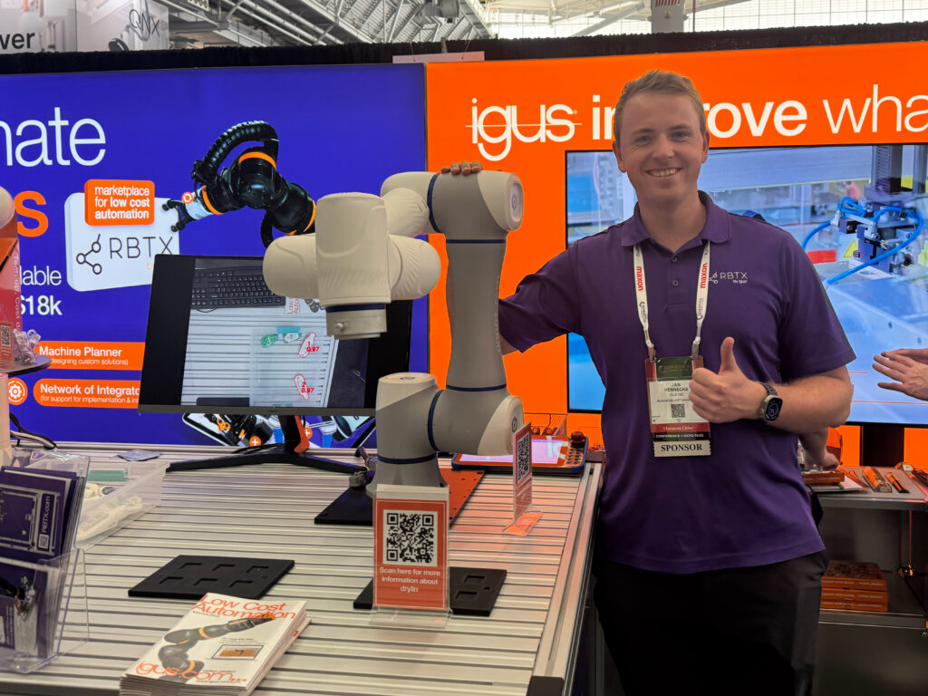 Jan Hennecke, business unit manager for robotics and automation at igus Inc., stands next to a Fairino FR20 cobot used for end-of-line palletizing and precise stacking through integrated controls at the 2026 Robotics Summit & Expo in Boston.