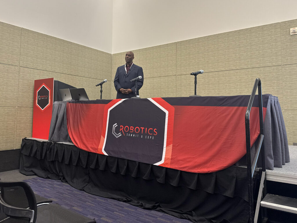 Anthony Jules, co-founder and CEO of Robust.AI, speaks during his session “Building Warehouse Robots People Actually Want to Work With” at the 2026 Robotics Summit & Expo in Boston.