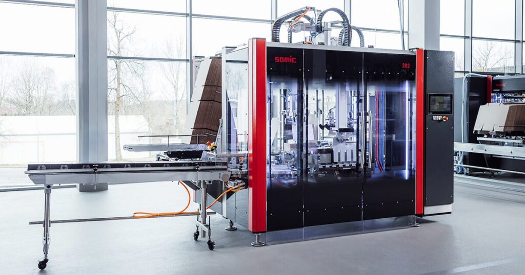 The SOMIC 202 cartoner is designed for standard packaging applications, handling RSCs, trays, and wraparound cartons at speeds up to 20 packs per minute.