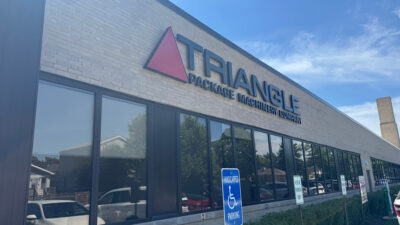 The entrance to Triangle Package Machinery's facility in Chicago, Illinois. The 103-year-old OEM recently announced SmartChange technology, which guides operators through changeovers on X-Series vertical form-fill-seal (VFFS) packaging systems.