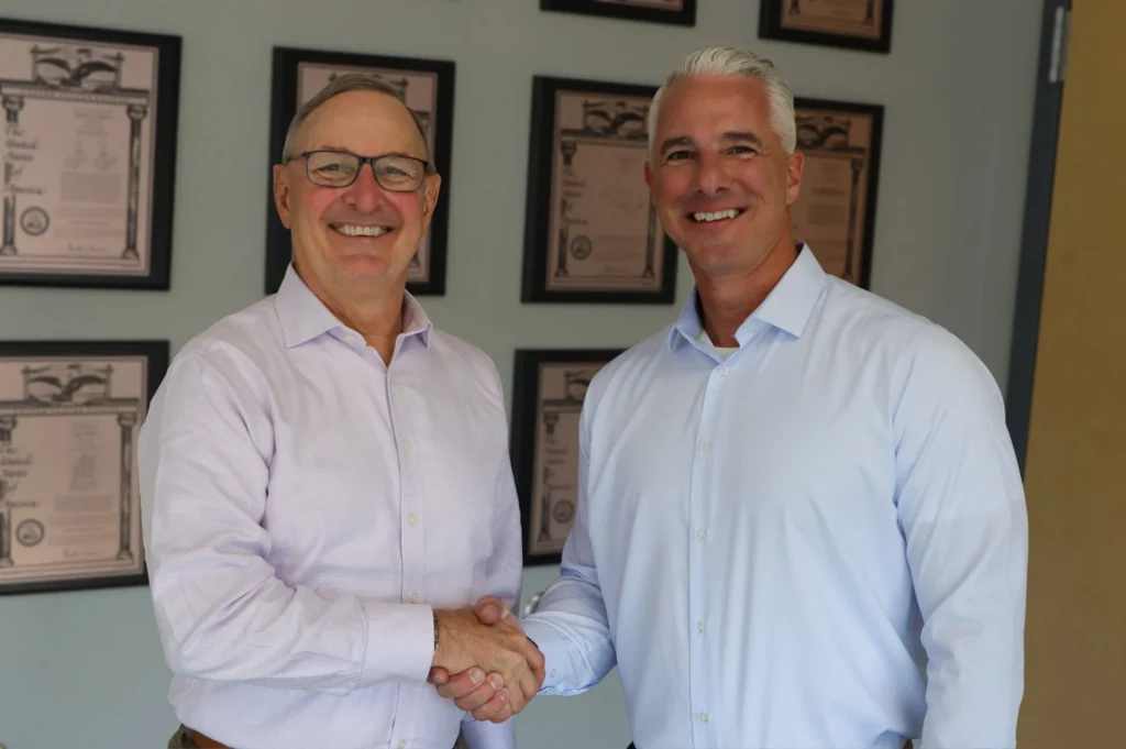 Craig Souser (left), who retired Oct. 12 after nearly five decades leading JLS Automation, and Russ Stroner (right), the company’s new President and CEO. JLS Automation manufactures hygienic robotic packaging systems.