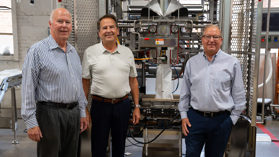 Triangle Package Machinery CEO Bryan L. Muskat, vice president of business development Paul Muskat, and vice president of manufacturing, safety and environmental services David Muskat stand on the shop floor at the company’s Chicago manufacturing facility.